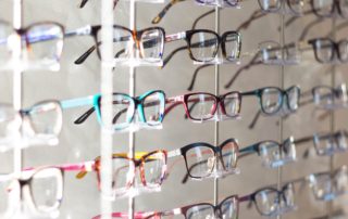 glasses sitting on wall at Eye Wares store schedule your eye exam, optometry near me, optometrist, eye doctor Metairie, eye doctor New Orleans, glasses store near me, eye clinic near me